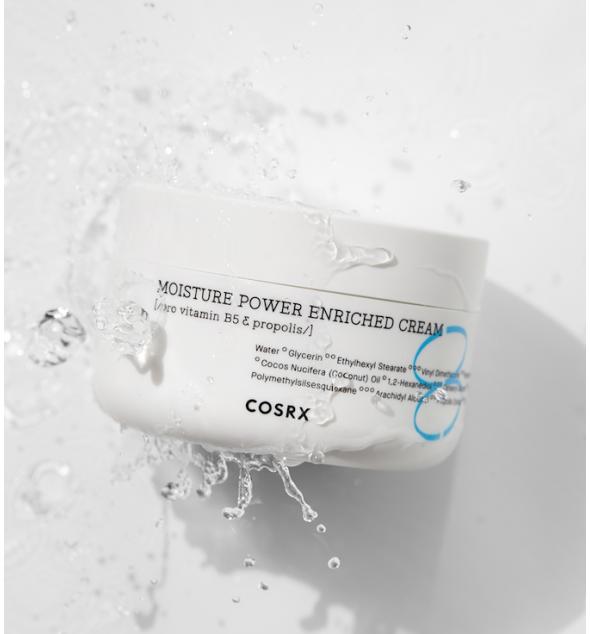 Cosrx moisture power enriched cream jar with water droplets on a light gray background
