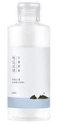 A bottle of Round Lab Dokdo Lotion 200ml with a label featuring Ulleungdo Island imagery.