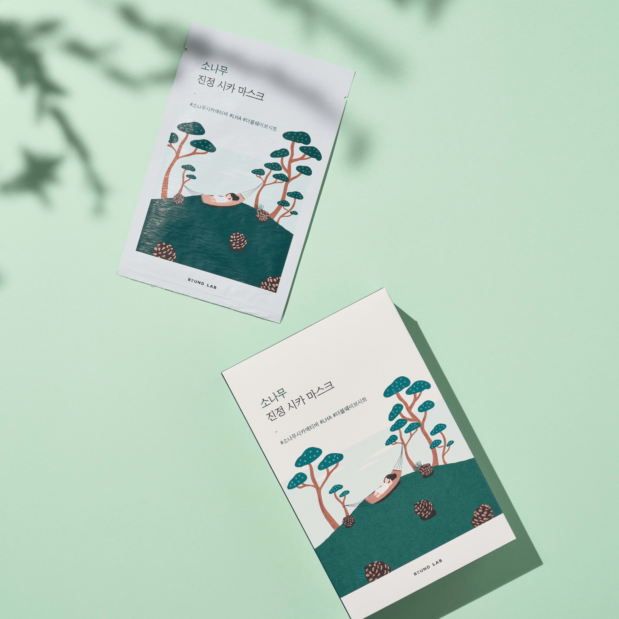 Packaging of Round Lab Pine Calming Cica Sheet Mask with a green and white color scheme, displaying the product name and description.